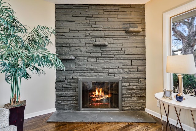 interior details with wood-type flooring and a fireplace