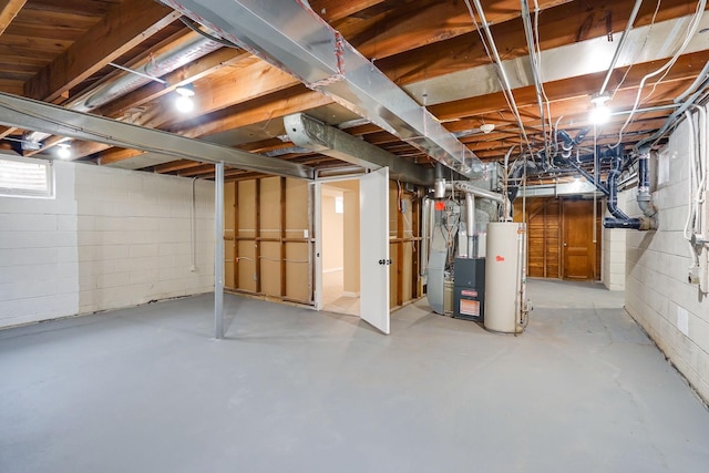 basement featuring gas water heater and heating unit