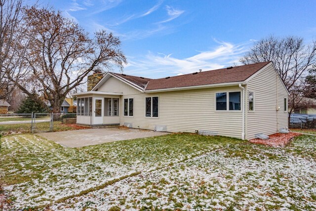 back of house with a yard, a patio, and a sunroom