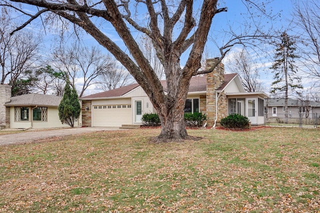 ranch-style home with a front yard and a garage