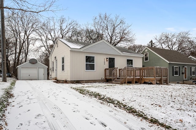 view of front facade featuring a wooden deck, an outdoor structure, and a garage