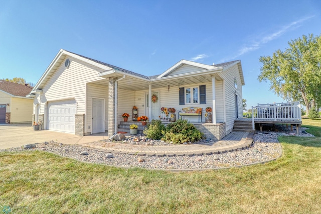 single story home with covered porch, a garage, and a front lawn