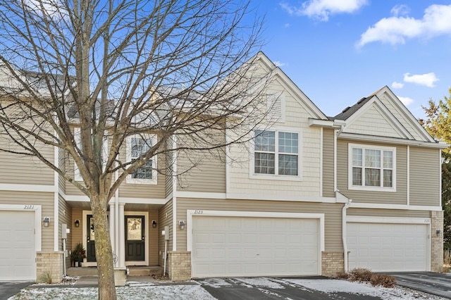 townhome / multi-family property featuring a garage