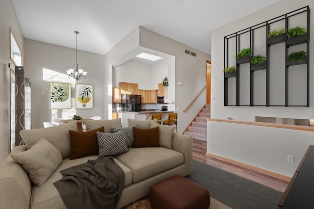 living room with a notable chandelier and wood-type flooring