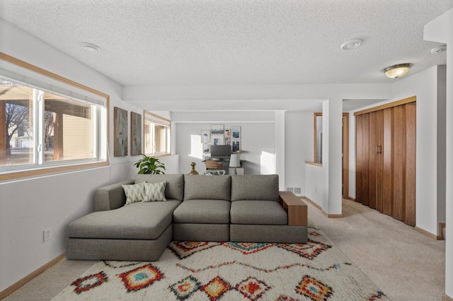 carpeted living room with a textured ceiling