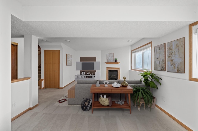 living room with light carpet and a textured ceiling