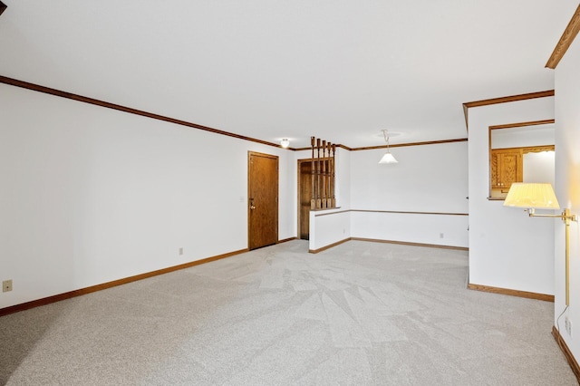 carpeted spare room featuring ornamental molding