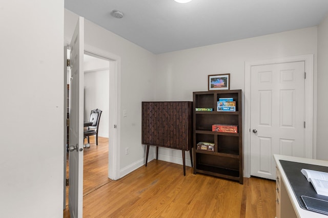 office space featuring light wood-type flooring and baseboards