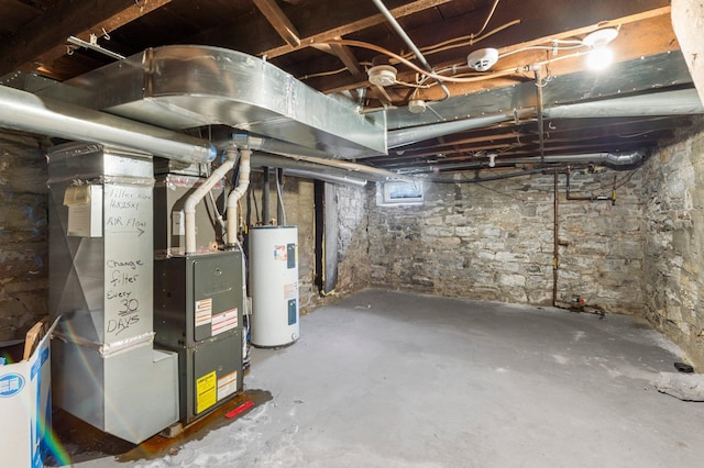 unfinished basement with heating unit and electric water heater