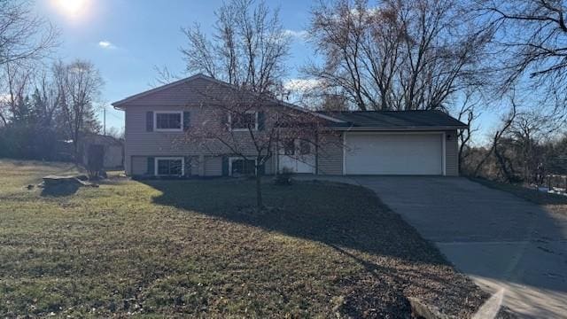 tri-level home with a garage and a front lawn