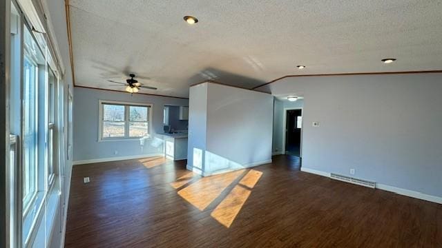 spare room with ceiling fan, dark hardwood / wood-style flooring, ornamental molding, and a textured ceiling