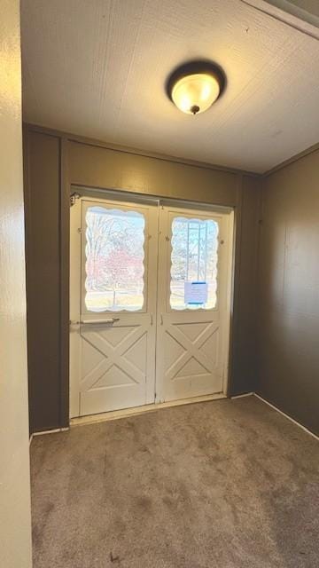 entryway featuring french doors and carpet floors