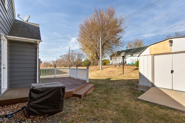 view of yard with a shed and a wooden deck