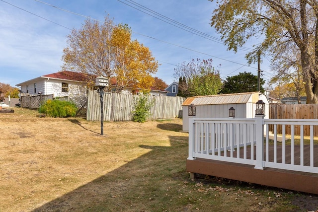 view of yard with a shed and a wooden deck