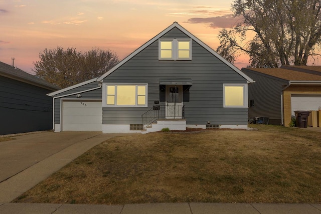 view of front facade featuring a garage and a lawn