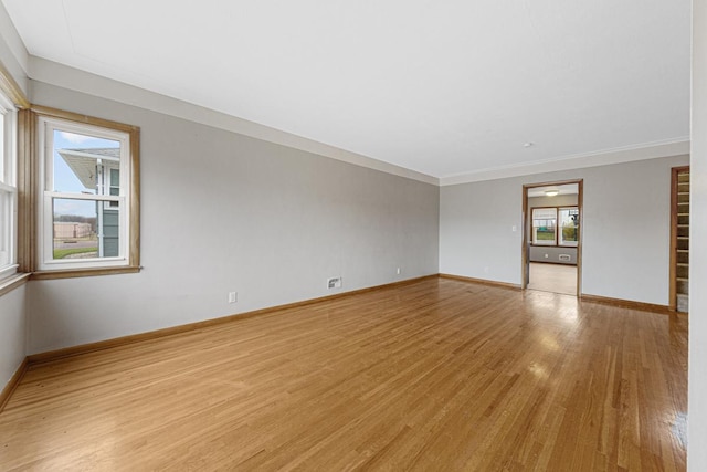 unfurnished room featuring light wood-type flooring and ornamental molding