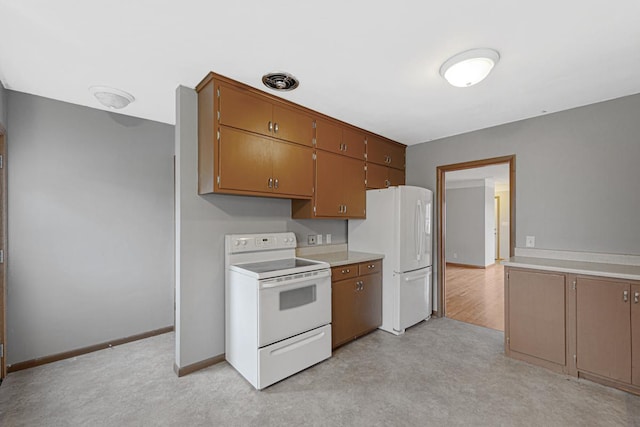 kitchen featuring light carpet and white appliances