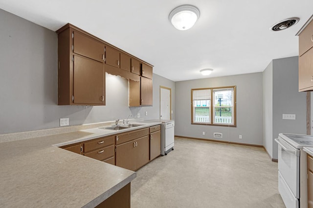 kitchen featuring light carpet, sink, and white appliances