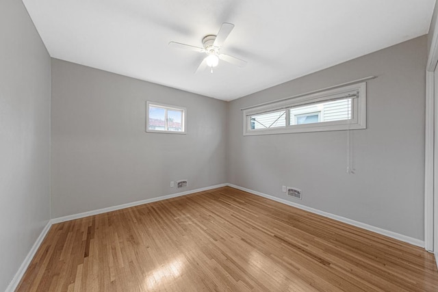 empty room with ceiling fan and light hardwood / wood-style floors