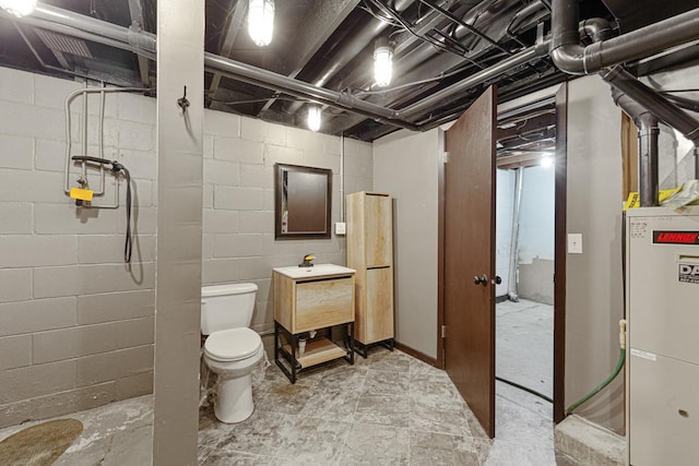 bathroom featuring vanity, toilet, a shower, and water heater