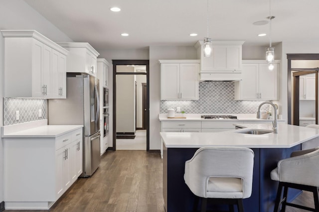 kitchen featuring white cabinets, decorative light fixtures, and sink