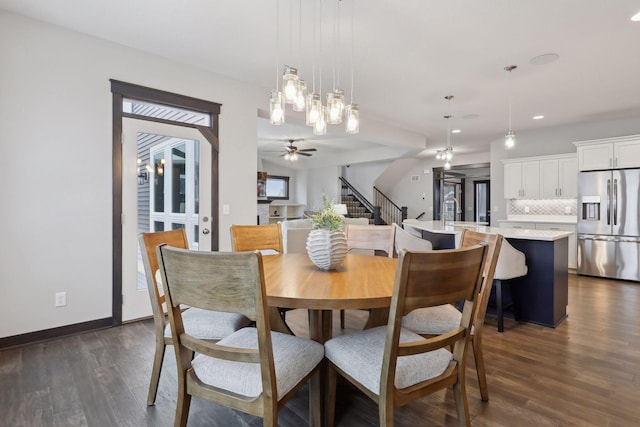 dining room with ceiling fan and dark hardwood / wood-style flooring