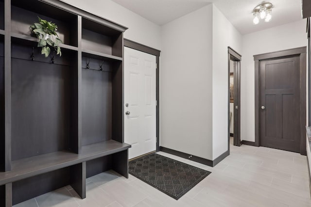 mudroom with a textured ceiling