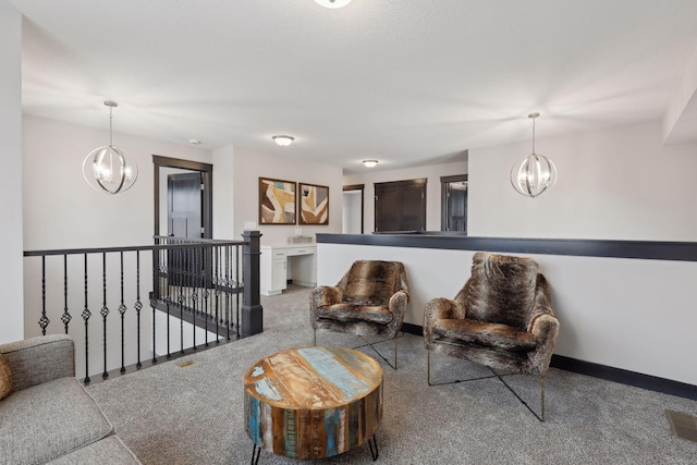 carpeted living room with an inviting chandelier