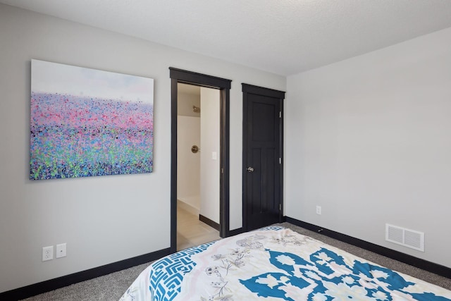 bedroom featuring carpet and a textured ceiling