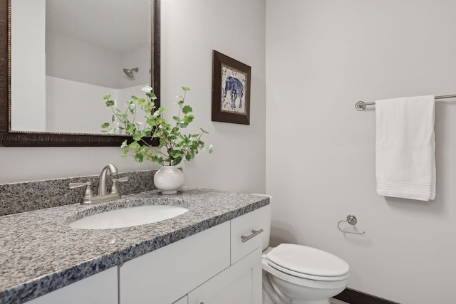 bathroom with vanity, toilet, and walk in shower