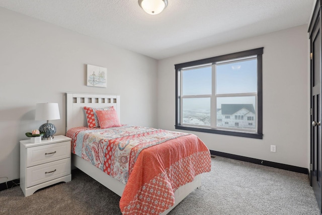 carpeted bedroom featuring a textured ceiling