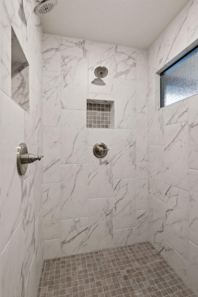 bathroom with a tile shower