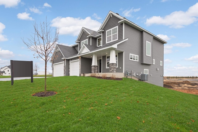 craftsman house with covered porch, central air condition unit, and a front lawn