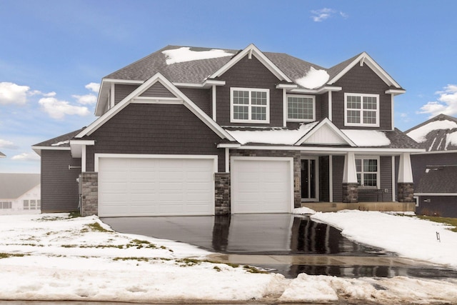 craftsman inspired home featuring driveway and stone siding