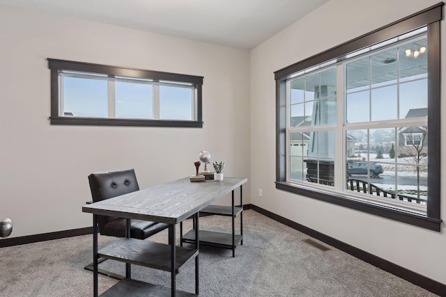 office space featuring carpet, visible vents, and baseboards