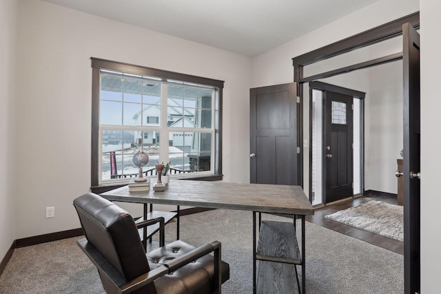 home office with dark wood-style floors and baseboards