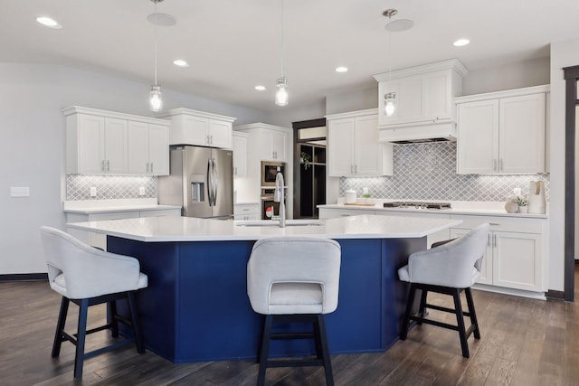 kitchen featuring stainless steel appliances, light countertops, and white cabinetry