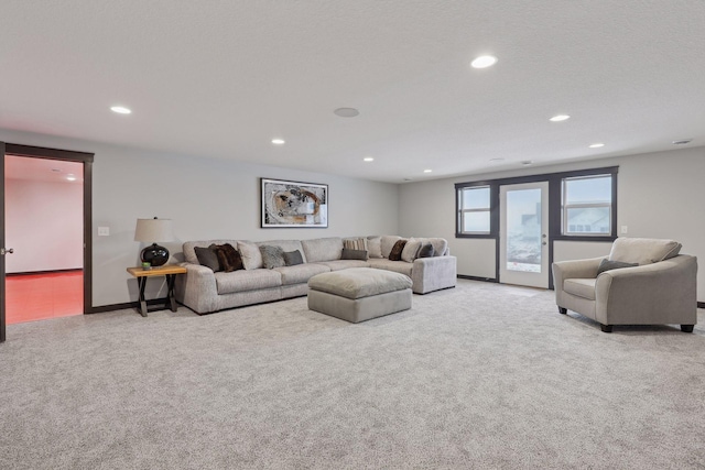 living room with recessed lighting, baseboards, and light colored carpet