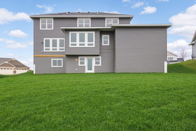 rear view of house featuring a yard