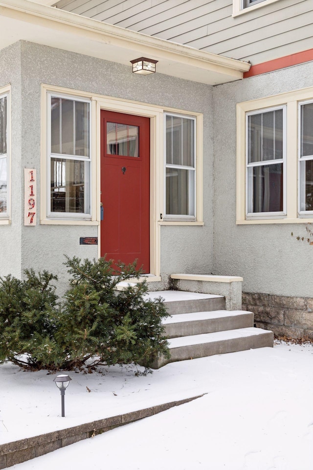 view of snow covered property entrance