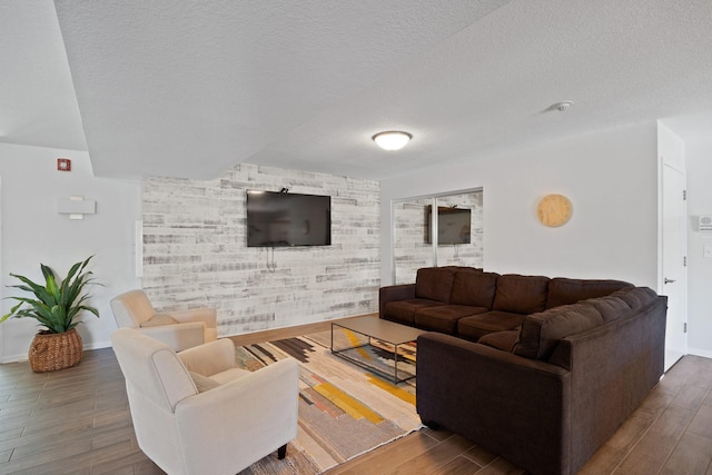 living room with dark hardwood / wood-style flooring and a textured ceiling