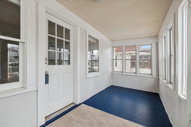 unfurnished sunroom featuring a wealth of natural light