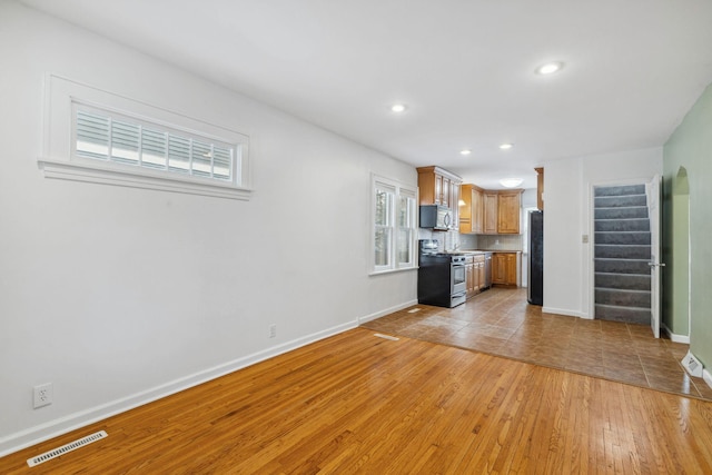 unfurnished living room featuring light wood-type flooring