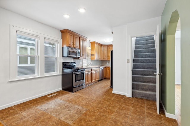 kitchen featuring appliances with stainless steel finishes and decorative backsplash