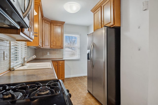 kitchen with tasteful backsplash, sink, light tile patterned flooring, and appliances with stainless steel finishes