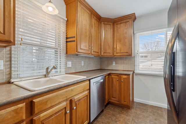 kitchen with sink, backsplash, light tile patterned floors, and appliances with stainless steel finishes