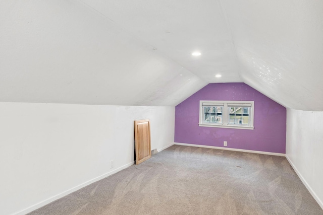 additional living space featuring lofted ceiling and carpet floors