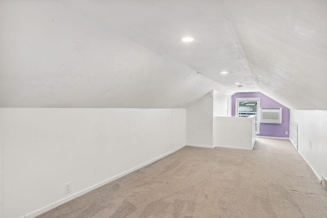 bonus room with vaulted ceiling and light carpet