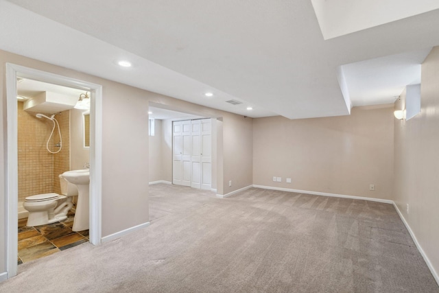 basement featuring light carpet