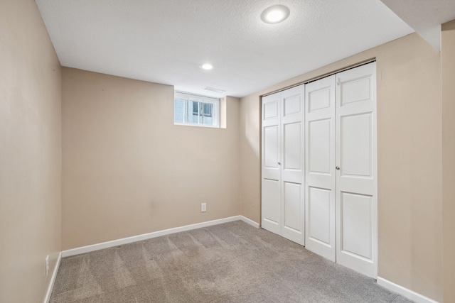 unfurnished bedroom featuring light colored carpet and a closet